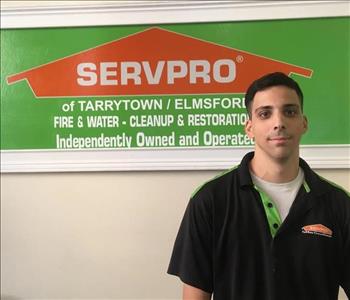 male employee in front of a SERVPRO sign